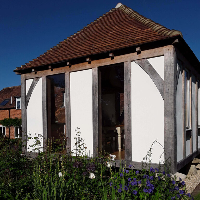 Wooden and glass building with garden.