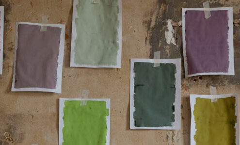 Paper paint swatches on a wall.