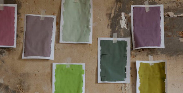 Paper paint swatches on a wall.