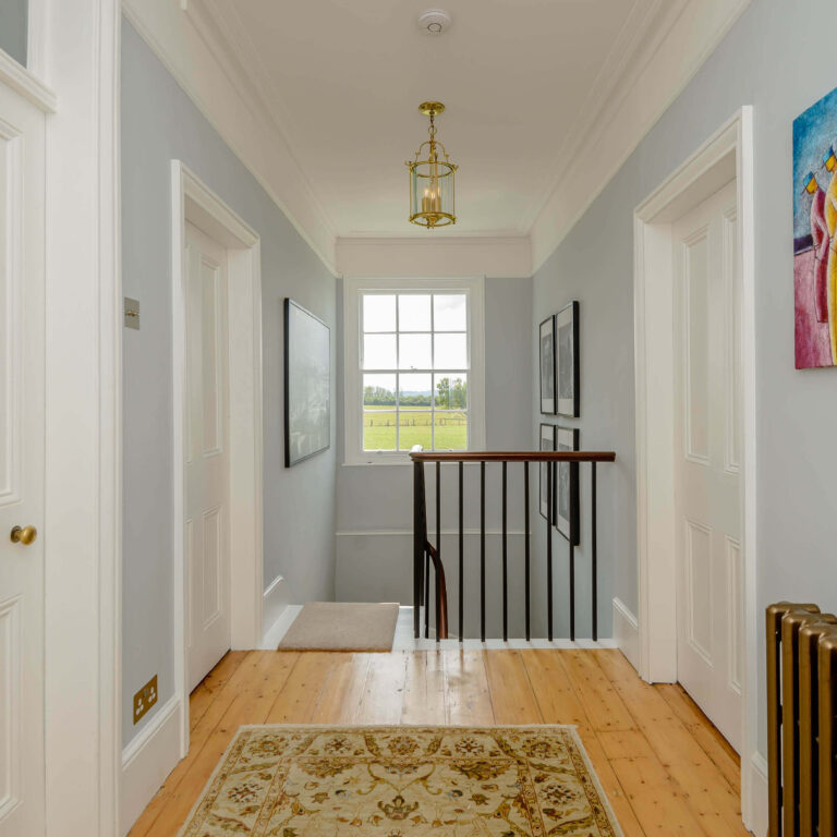 Upstairs hallway facing a window.