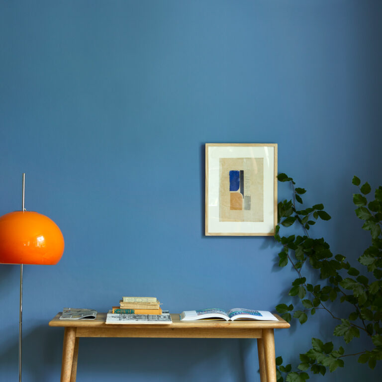 Skipper behind a simple desk.