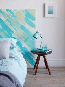 Coastal interiors bedroom design idea, a painted headboard