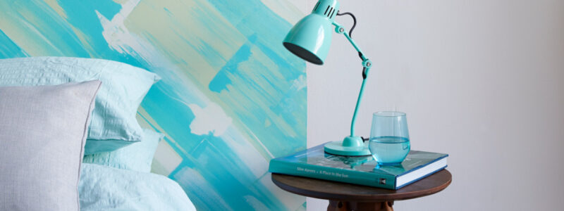 Coastal interiors bedroom design idea, a painted headboard