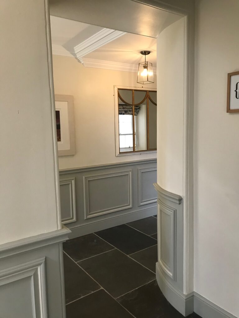 A door way leading to a passage way with paint for listed buildings