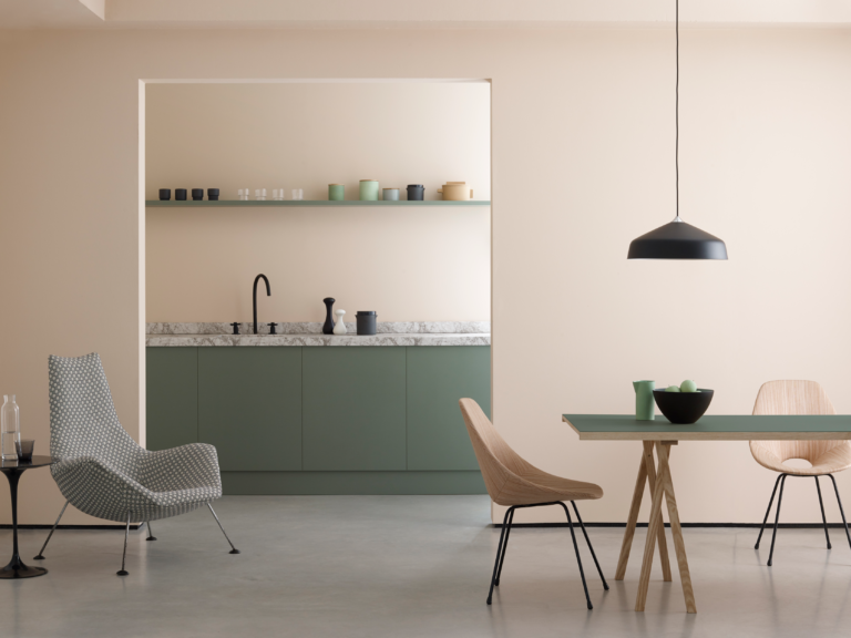 An open dinning room looking into a minimal kitchen.