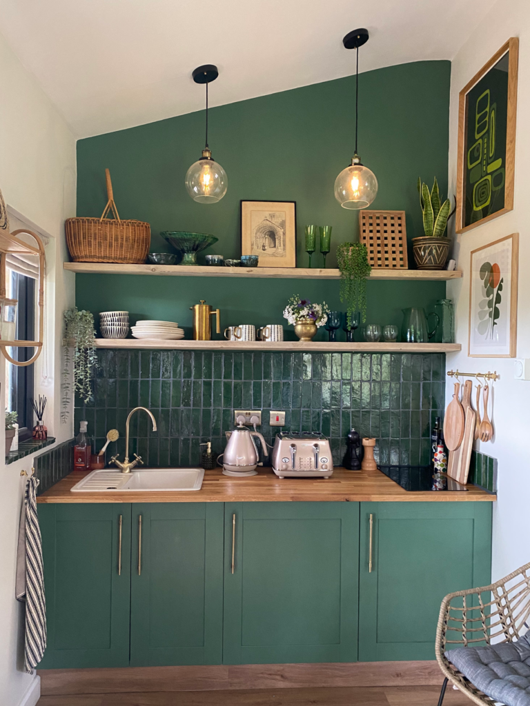 Kitchen nook with the wall and cabinets painted green.