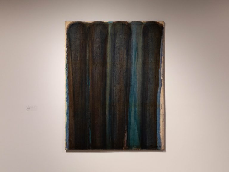 Painting hang on a gallery wall.