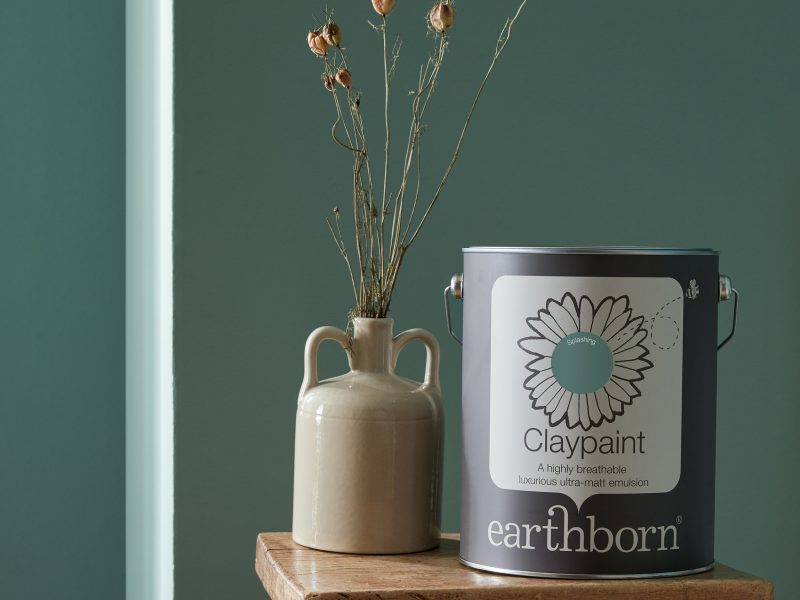 Splashing wall with paint tin.