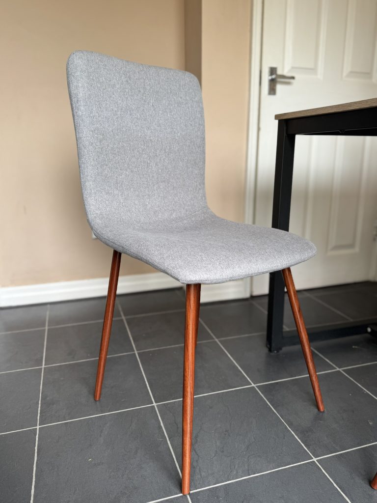 A before image of a grey fabric chair.