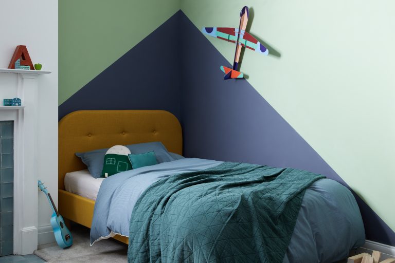 A kids bedroom with blue and green painted walls