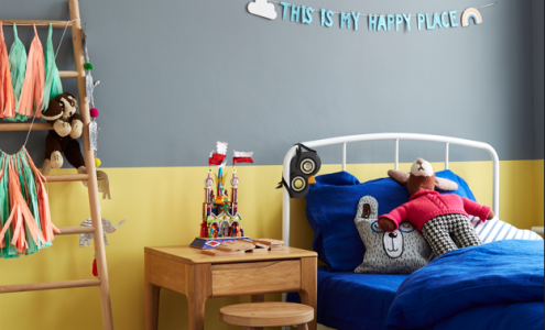 Childs bedroom with walls painted in yellow and grey paint